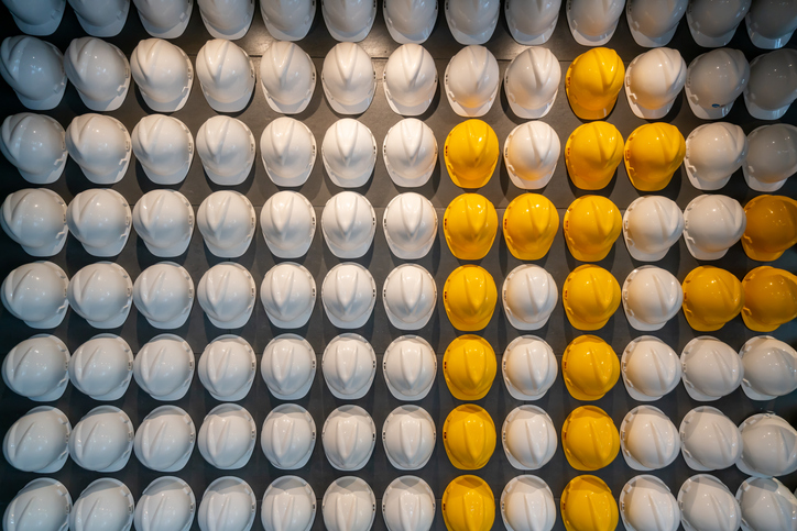 Rows of white and yellow hard hats